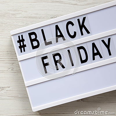 `Black friday` words on a lightbox on a white wooden surface, top view. Close-up Stock Photo