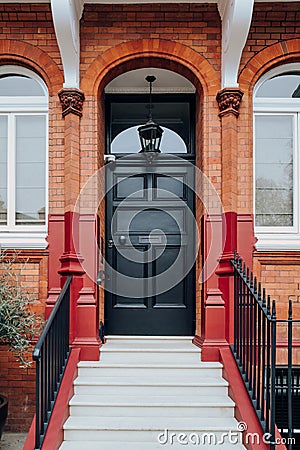 Black front door of a traditional house in London, UK Stock Photo