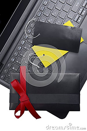 Black gift box with red ribbon and colorful label tag on the laptop Stock Photo