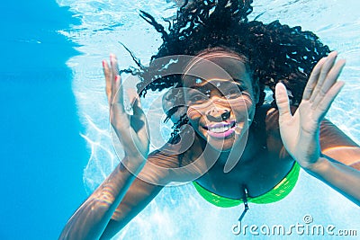 Black girl diving in swimming pool at vacation Stock Photo