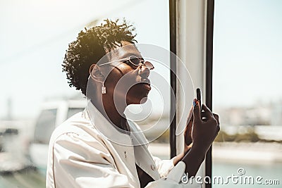 Black girl taking pics on cellphone Stock Photo