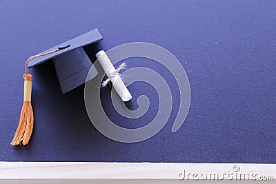 Black graduation cap, diploma in classroom. graduate certificat Stock Photo