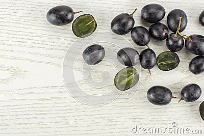 Fresh raw black grape on grey wood Stock Photo