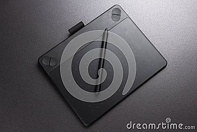 Black graphic tablet and pen. Designer tool for drawing. Stock Photo