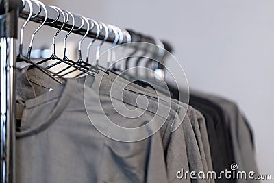 Black and gray female clothes of natural flax hang on a hanger i Stock Photo