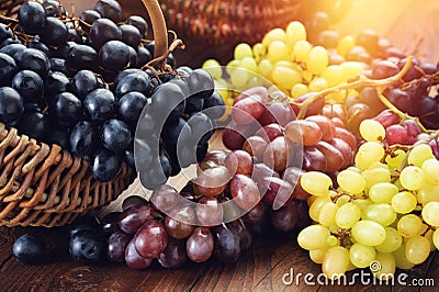 Black, green and purple grapes. Ripe bunches of grapes in a basket Stock Photo