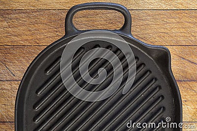 Black grill pan on wood background Stock Photo