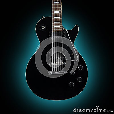 Black guitar isolated on blue background Stock Photo