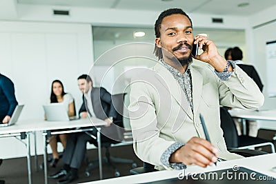 Black handsome graphics designer with dreadlocks using digitize Stock Photo