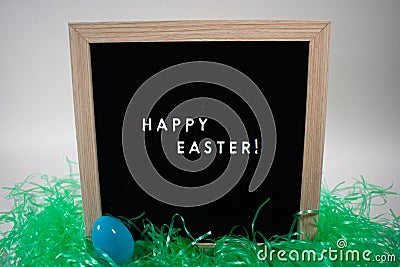 A Sign That Says Happy Easter With Easter Eggs Stock Photo