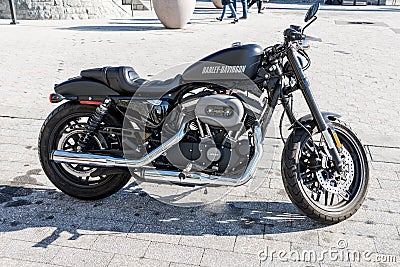 Black Harley Davidson motorcycle roadster with chrome Editorial Stock Photo