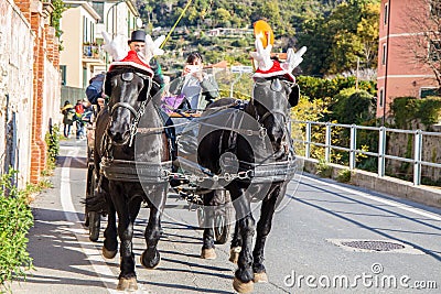 Black horses with carriage with funny Christmas hats, Italy Editorial Stock Photo