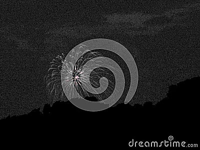 Fireworks explode over nightsky hillside monochrome. Stock Photo