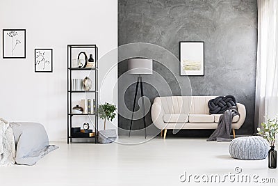 Black, industrial shelving unit, gray knot pillow on a leather s Stock Photo