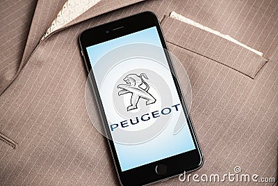 Black iPhone with logo of French car factory Peugeot on the screen. Editorial Stock Photo