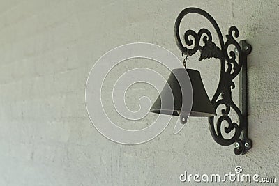 Black Iron Door Bell on Gray Rendered Brick Wall. Stock Photo