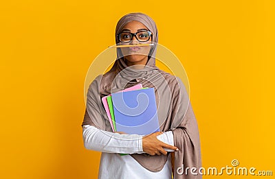 Black islamic female student in hijab holding pencil like mustache Stock Photo