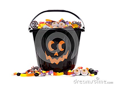 Black Jack o Lantern candy collector with candy pile over white Stock Photo