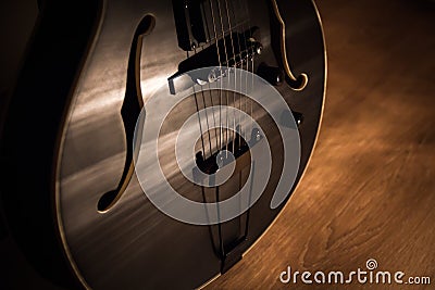 Black jazz archtop guitar with holes. hollow steel-stringed acoustic or semiacoustic Stock Photo