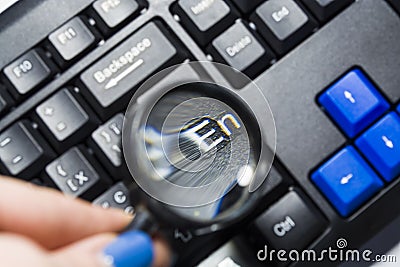 The black keyboard from the computer with a magnifying glass. Keys enter and shift. Tool. Press. Typing. Stock Photo