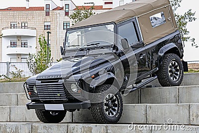 Black Land Rover Defender off-road jeep on concrete stairways during an exhibition in a park Editorial Stock Photo