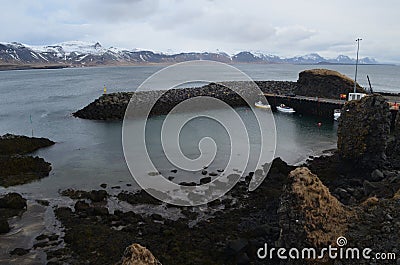 Black Lava Rocks Along the Coast of Hellnar Iceland Stock Photo