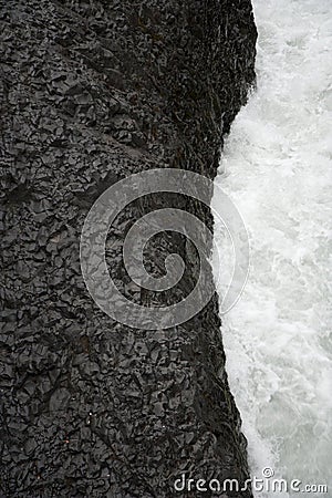 Black lava and white water Stock Photo