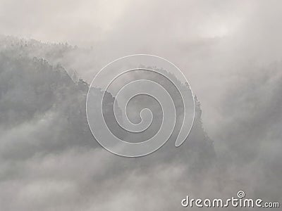 Black leather cowboy hat lays on peak above misty country Stock Photo