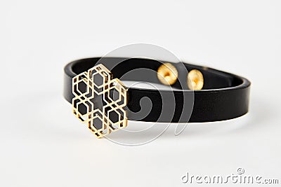 Black leather and gold cuff bracelet on white background with copy space Stock Photo