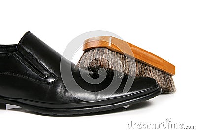 Black leather shoe and brush Stock Photo
