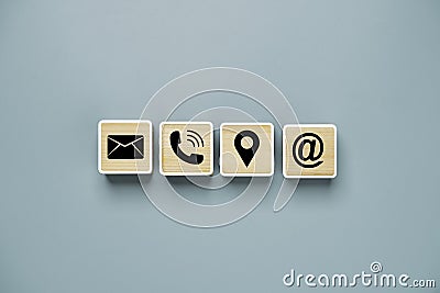 Black letter telephone location and address icons print screen on wooden cube block for customer service contact concept Stock Photo