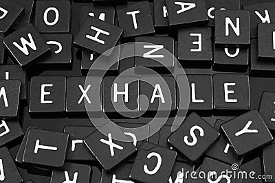 Black letter tiles spelling the word & x22;exhale& x22; Stock Photo