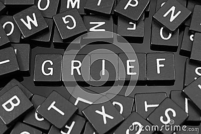 Black letter tiles spelling the word & x22;grief& x22; Stock Photo