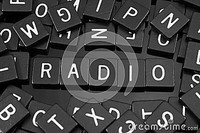 Black letter tiles spelling the word & x22;radio& x22; Stock Photo