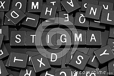 Black letter tiles spelling the word & x22;stigma& x22; Stock Photo