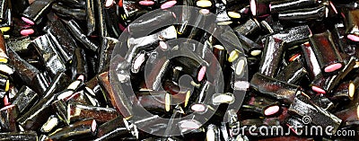 Black licorice candies filled with colored sugar Stock Photo