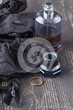 Black lingerie set, stockings, lace up corset choker on table background. women underwear Stock Photo