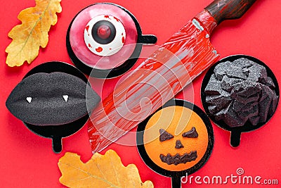 Black lips with vampire fangs, a torn eye, an ominous pumpkin and black mountain. Halloween scary mousse cake with Stock Photo