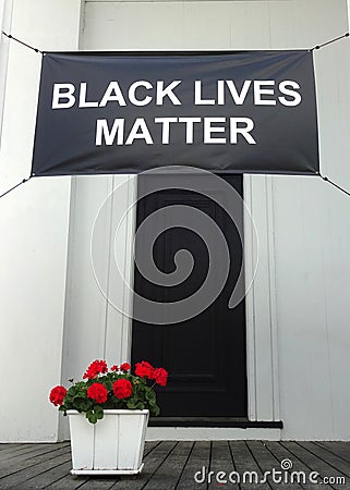 A Black Lives Matter banner hangs on the front porch of a church Editorial Stock Photo