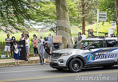 Police Car Drives By Protestors at Police Station Editorial Stock Photo