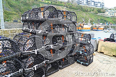 Black lobster pots on harbour quay Stock Photo
