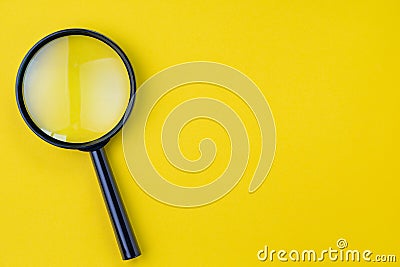 Black magnifying glass, magnifier on yellow background with copy Stock Photo