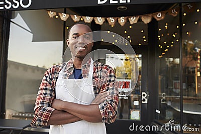 Black male business owner standing outside coffee shop Stock Photo