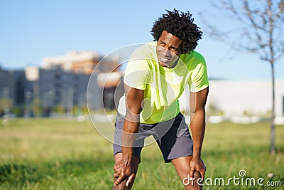 Black man with afro hair exhausted after exercising. Stock Photo