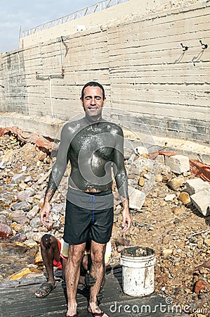 Black man, filled with mud to a European man Editorial Stock Photo