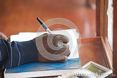 Black man hand with pen Stock Photo
