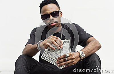 Black man holding cash bills Stock Photo