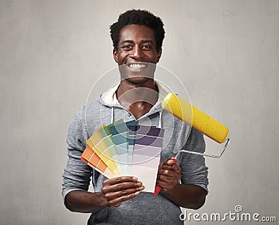 Black man with painting roller Stock Photo