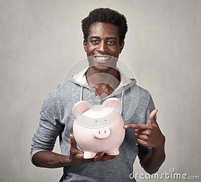 Black man with piggy bank. Stock Photo