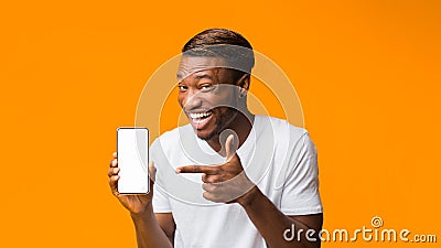 Black Man Showing Phone Blank Screen Standing, Orange Background, Mockup Stock Photo